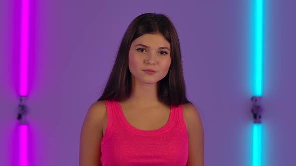 Portrait of Fashionable Model Coquettishly Looking at Camera alt