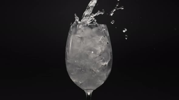 Mineral Water Pouring Ice Glass Closeup alt