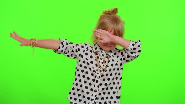 Cheerful Little Kid Child Girl Having Fun Dancing and Moving to Rhythm Dabbing Raising Hands alt