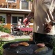 Detail Senior Men Putting Meat on Grill