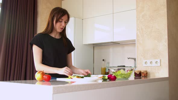 Woman Preparing Sandwich in Kitchen