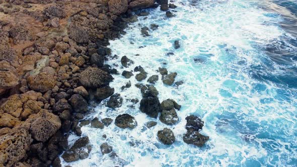 Sea Waves Washes the Rocky Shore Aerial Top View alt