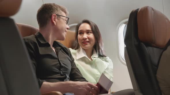 Couple in love traveling in airplane, Feeling excited and happy for honeymoon sweet travel trip