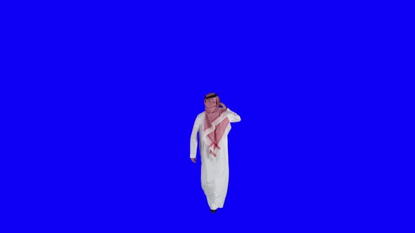 saudi man walking and waiting, talking on the phone - green and blue screen. alt