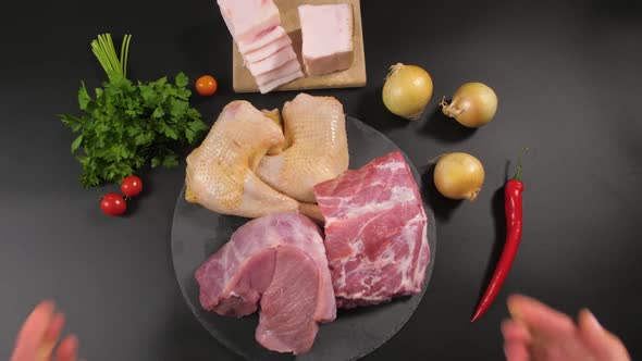 The Chef's Hands Put on a Background of a Stone Plate with Pieces of Raw Meat of Veal Pork Chicken