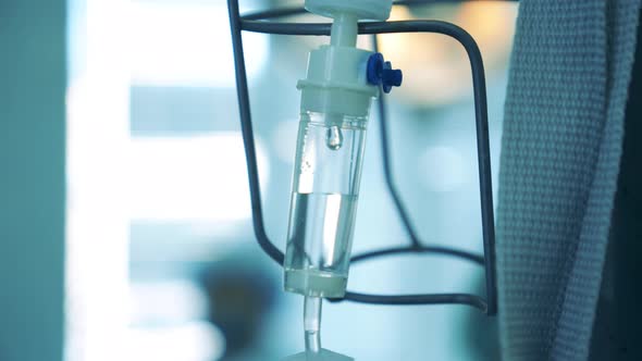 Clear Fluid Is Dropping in a Drip Vial in a Close Up alt