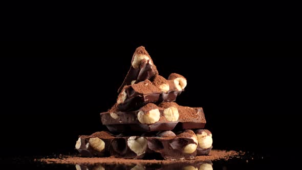 Chocolate. stack of chocolate bar with nuts and cocoa powder  alt