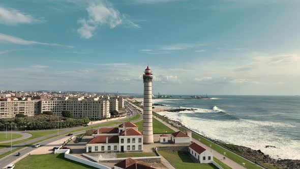 Aerial view over the lighthouse of  Leça da Palmeira, Matosinhos with the city and coastline behind. alt