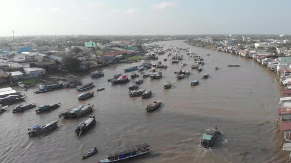 Aerial: flying over Cai Rang floating market on the river, Can Tho, Vietnam alt