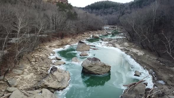 Roll Down Shot of Frozen River Driftwood alt