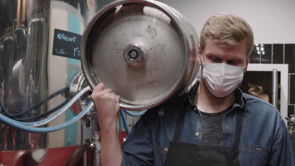 Man With Metal Barrel At Brewery alt