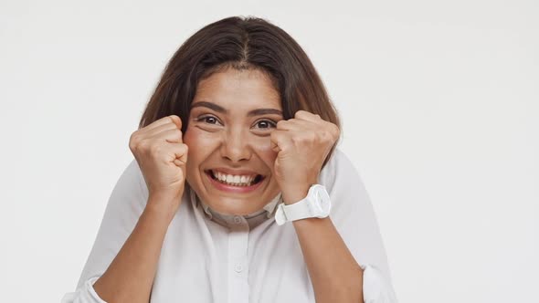 Young Beautiful Brunette East Asian Female in Shirt Actively Laughing Smiling in Amazement on White alt