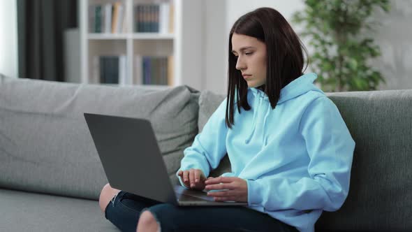 Woman Working on Laptop at Home