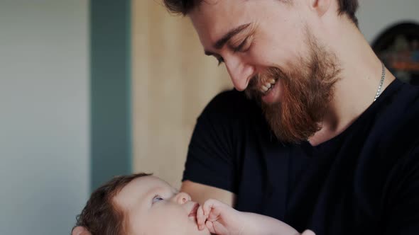 True Face Emotions of Happy Smiling Father with His Tiny Baby alt