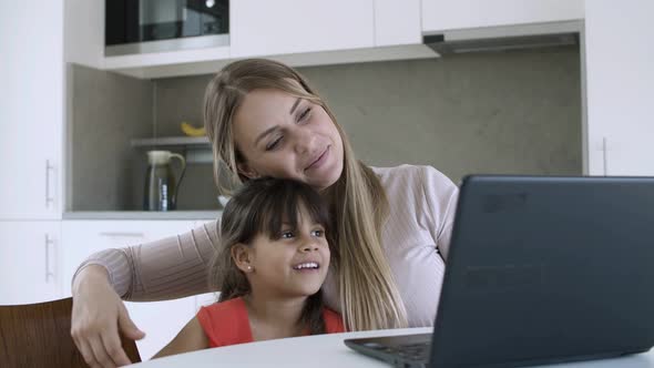 Cute Little Girl and Her Mom Watching Content alt