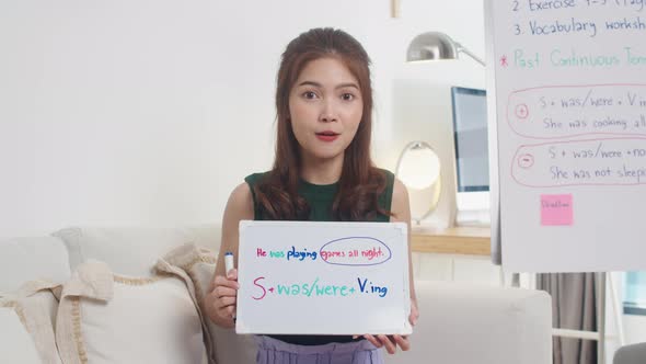 Asia young female english teacher video conference looking at camera talk by webcam.