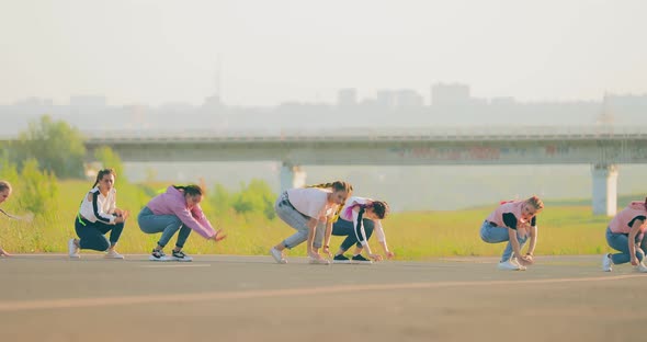 Girls in Jeans and Pigtails Dance Hiphop Dance in the Summer on the Road alt