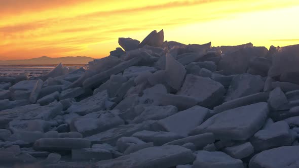 Color sunset landscape with stacks of ice in winter alt