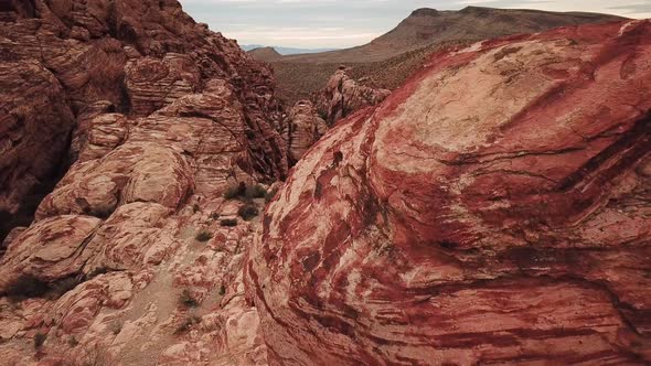 Dolly Forward from behind Large Rock in Red Rock Canyon to Reveal Canyon alt