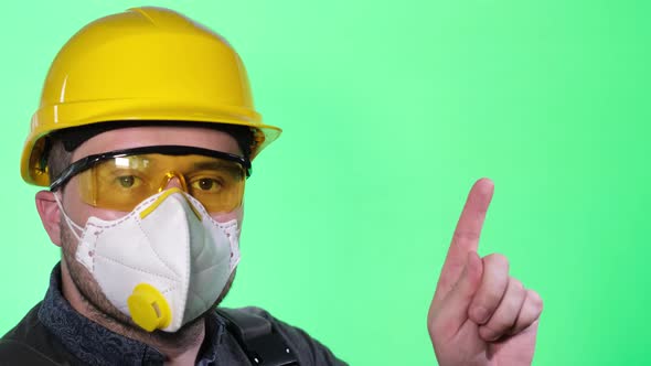 Male Builder in Respirator and Goggles on Green Background with Colored Key alt