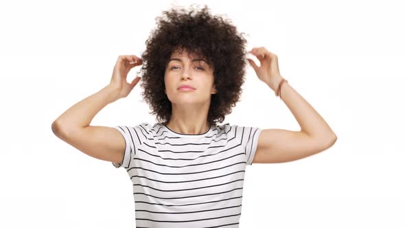 Close Up Portrait of Gorgeous Brunette Caucasian Woman Touching Her Shaggy Curly Hair Loving It alt