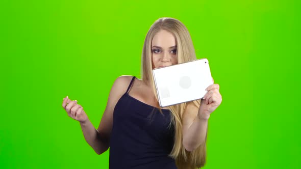Blonde Girl Makes Various Photos Using Camera of Tablet Pc alt
