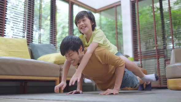happy asian family dad son weekend,healthy father doing push up exercise