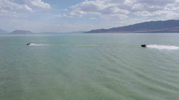 Riders on Jet Ski Sea Doos in Picturesque Beautiful Utah Lake - Aerial with Copy Space in Sky alt