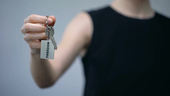 Freedom Word on Keychain in Female Hand, Women Rights, Independent Choice alt