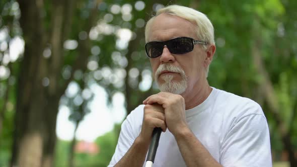 Upset Blind Old Man in Sunglasses Sitting in Park, Feeling Lonely an Depressed alt