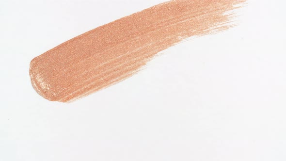 Macro Shot and Slow Motion of a Brush Applicator Smear Concealer Isolated on White Background alt