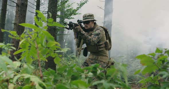 Soldier Moving Through Smokey Forest with Rifle Ready to Shoot Running Through Forest During alt