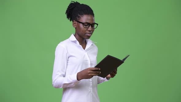 Young Beautiful African Businesswoman Reading Book