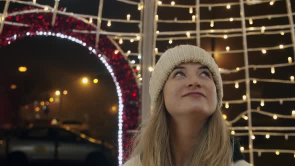 Woman Looking at Christmas Lights