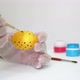 Happy Easter Close Up. A white man painting a yellow Easter egg in polka dot with purple color - VideoHive Item for Sale
