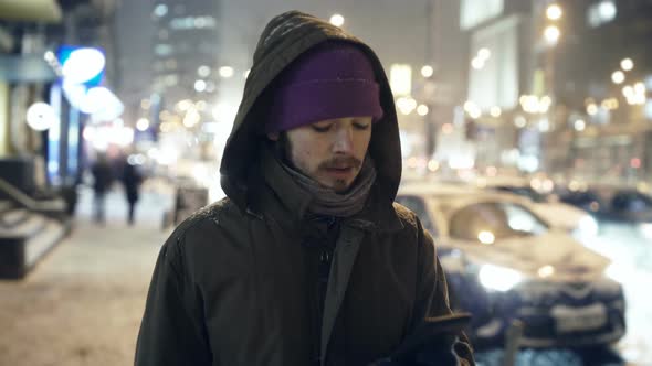 Man Ordering a Taxi With Smartphone App