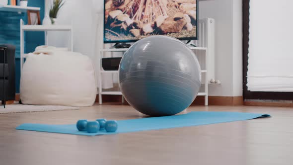 Empty Living Room with Sport Training Equipment on Floor alt