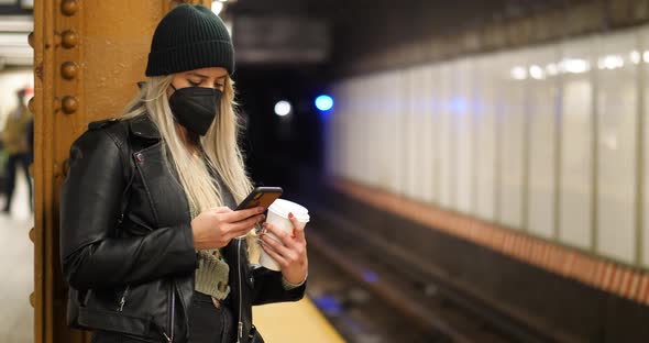 Woman Using Phone With Mask In Subway