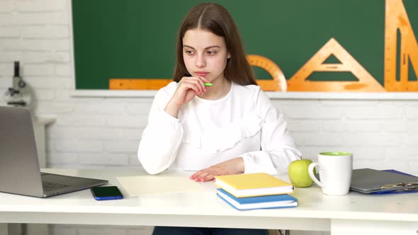 Pensive Kid Write in Copybook Doing Schoolwork in Classroom Lesson