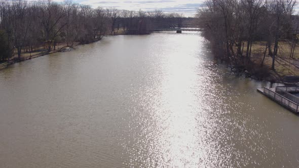 Aerial Drone Shot Ascending Over Lake With Bridge in Suburban New Jersey
