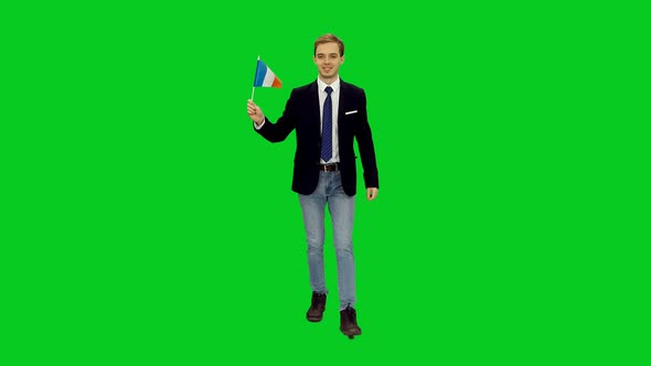 Young Stylish Businessman Walking with Waving Flag of France on Green Screen 