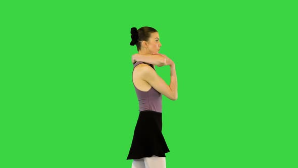 Young Ballerina in Training Clothes Walks Warming Up on a Green Screen Chroma Key alt