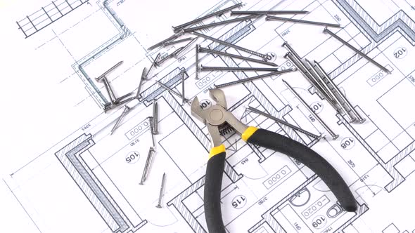 Wire Cutters with Yellow, Gray Handle on Building Plan, Scheme, Among Nails, Rotation alt