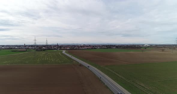 Aerial Drone Content  Road with Light Traffic on Outside City and Arable Lands