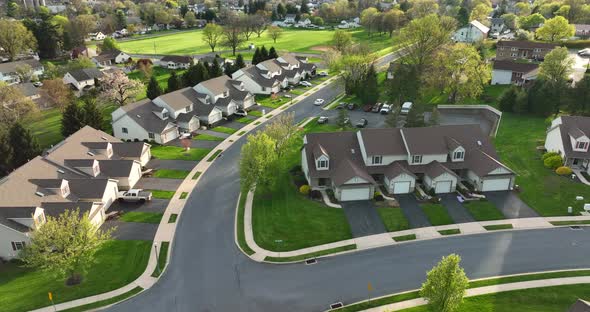 Townhouses and sidewalk in small town America. Golden hour light. Aerial in springtime season. Beaut alt