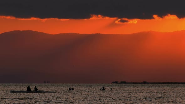 Canoe And Mussel Fishing People Silhouette In Sea And Sunset alt
