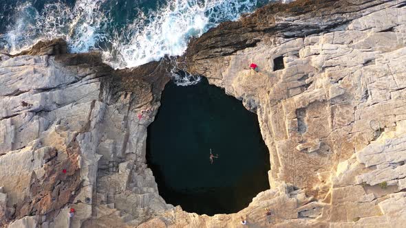Flying Above a Woman Swimming in a Natural Sea Pool.  Giola Lagoon, Thassos Island, Greece, Aerial alt