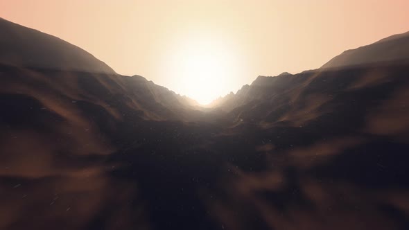 Flying over a mountain valley through the snow towards the sun, repeatable alt