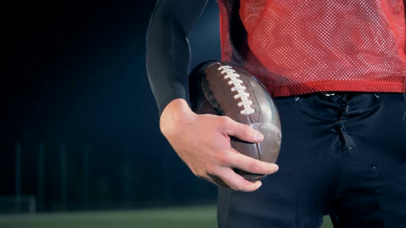 Man Holds a Ball in a Hand, Close Up. alt