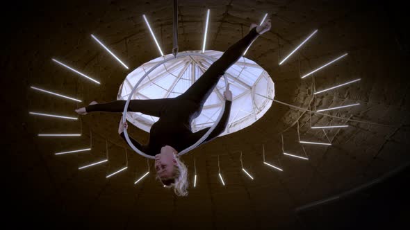 Female Gymnast Performing the Acrobatic Elements Upside on the Aerial Hoop